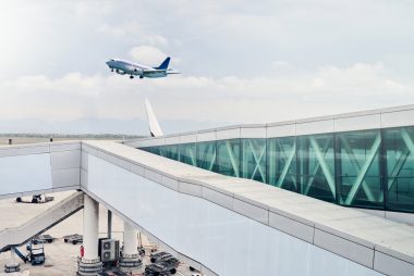 Airport, travel and airplane in sky in flight for takeoff, international and commercial transportation. Air transport, world and aeroplane leaving terminal to global destination, location and country.
